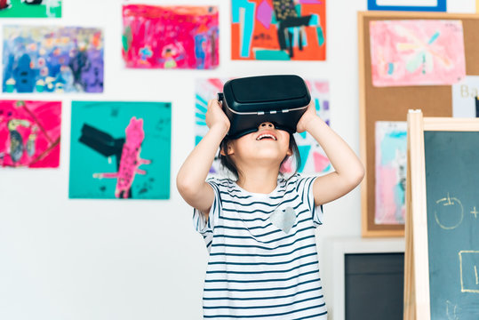 Preshool kids wearing virtual reality headset in classroom