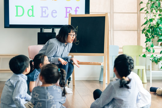 Teacher and preschool kids in classroom