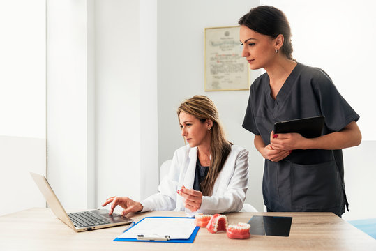 Doctor and nurse working in dental clinic together.
