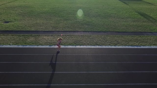 aerial shot of girl running at a track