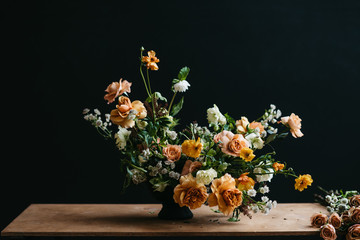 Florist in studio building a stunning floral arrangement