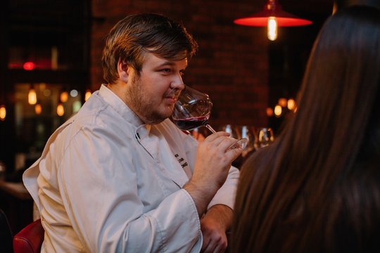 Closeup portrait of man with glass of red wine at restaurant