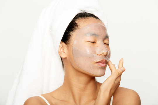 Young Beautiful Asian Woman Applying Facial Gel Mask