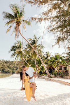 Young woman and man kissing on the beach