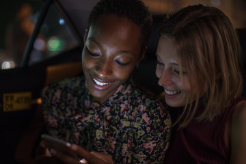 Three girls in a taxi together