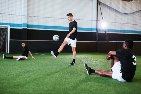 Soccer players training in football field.