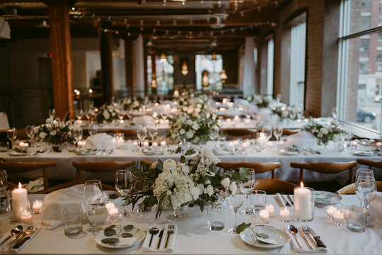 Long tables set up for wedding reception inside old building