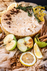 Biscuit apple pie with cinnamon, citron, oriental spices and sugar powder on dark background