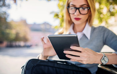 Business woman sitting and working in the park. Business, education, lifestyle concept