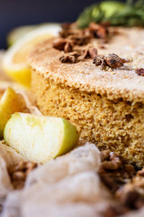 Biscuit apple pie with cinnamon, citron, oriental spices and sugar powder on dark background