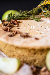 Biscuit apple pie with cinnamon, citron, oriental spices and sugar powder on dark background
