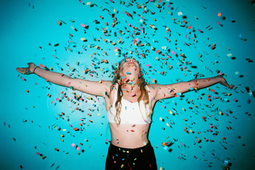 confetti against blue backdrop with teenager girls
