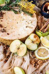 Biscuit apple pie with cinnamon, citron, oriental spices and sugar powder on dark background