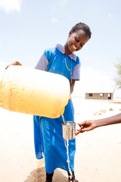 Schoolgirls drinking clean water. Kenya. Africa