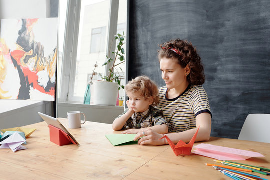 Mom and son watching origami tips