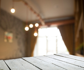 Empty wooden table in front of abstract blurred background of coffee shop . can be used for display or montage your products.Mock up for display of product