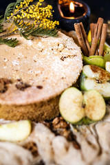 Biscuit apple pie with cinnamon, citron, oriental spices and sugar powder on dark background
