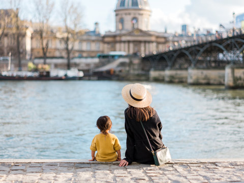Mom and baby sitting on Seine River