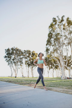 Girl Running on Sunny Path in San Diego