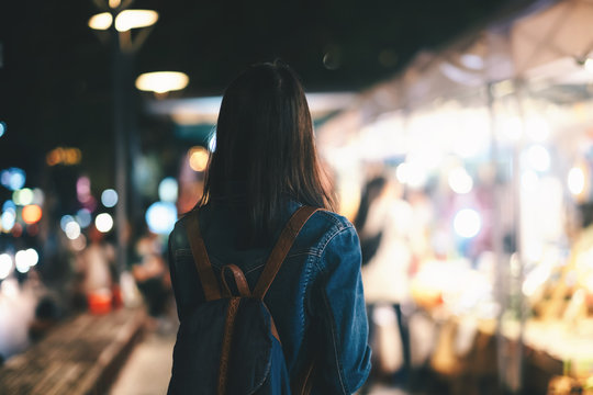 Young Traveller Woman Walking On City Street At Night.