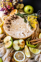Biscuit apple pie with cinnamon, citron, oriental spices and sugar powder on dark background
