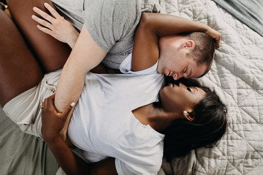 Couple Cuddled In Bed Sleeping