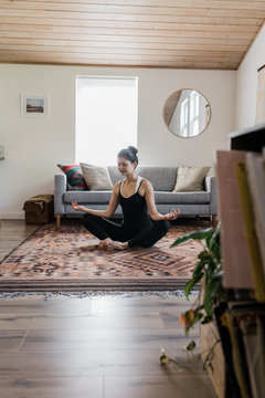 young female indoors practicing yoga