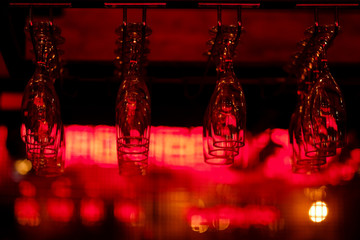 wine glasses placed upside down on a bar
