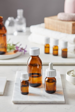 Essential oils in brown glass bottles of different size.