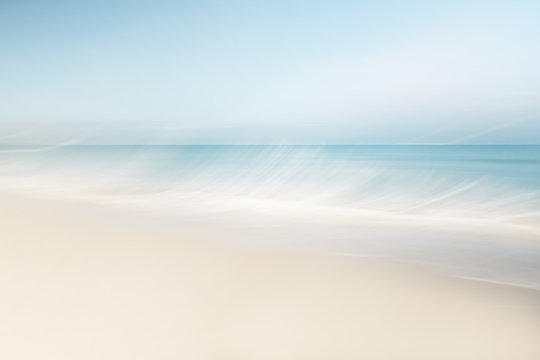 Blurred waves at the beach on a clear day in spring