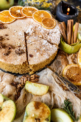 Biscuit apple pie with cinnamon, citron, oriental spices and sugar powder on dark background