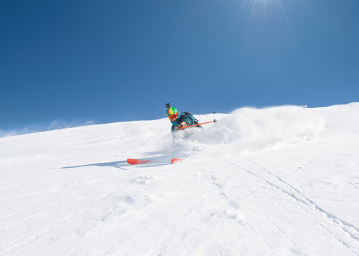 Freeride skier in fresh powder snow