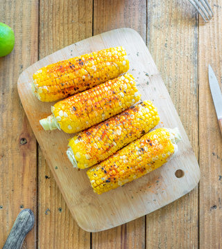 Grilled corn on the cob with spices, cheese, and herbs. Also known as Mexican Elote
