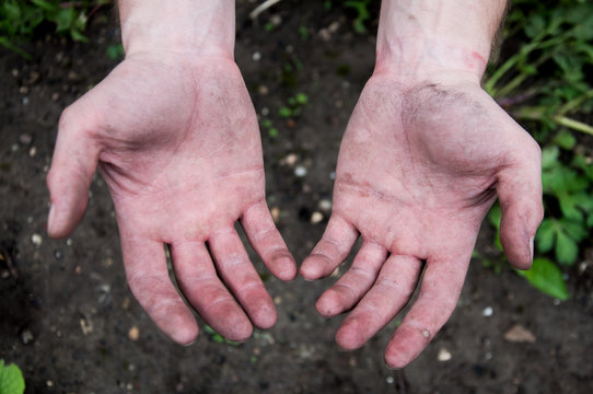 Outstretched Both Hands Against The Ground. Dirty Hands