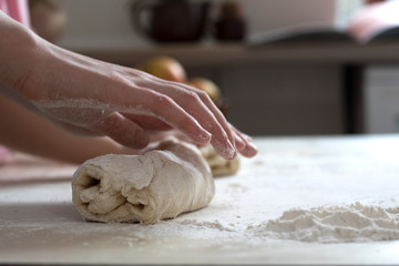 Children mold cheesecakes from dough. Kitchen table in flour. Warm relationships children