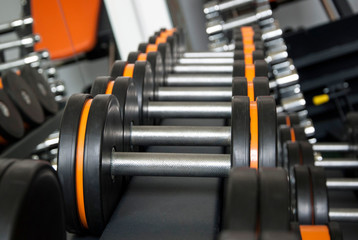 Obraz premium Sports dumbbells in modern sports club. Weight Training Equipment
