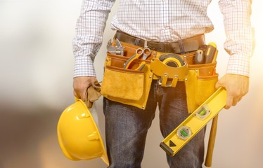Fototapeta na wymiar Male worker with tool belt isolated on white background