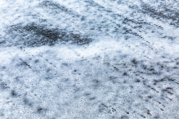 Texture of sea foam on sand, closeup. Background. Space for text.