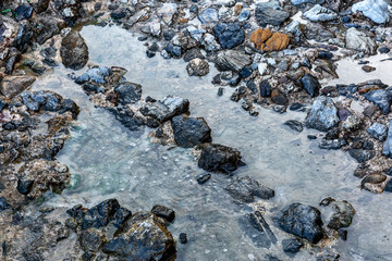 Stony sea shore, close-up. Space for text.