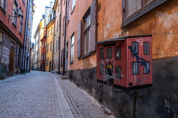 Fototapeta na wymiar The picture from the narrow traditional streets of Stockholm. Walking inside the Gamla Stan. 