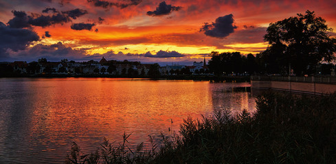 Naklejka premium Dramatic sunset with the Schwerin old town in the background. Mecklenburg-Vorpommern, Pomerania, Germany