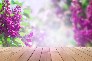 Delicate floral background lilac flowers on a bright sunny day. Blurred lilac floral background. Lilac flowers on wooden table background
