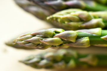 bunch of fresh asparagus on a wooden background. veganism and raw foods