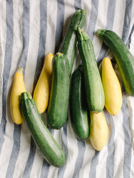 Zucchini and squash on striped towel