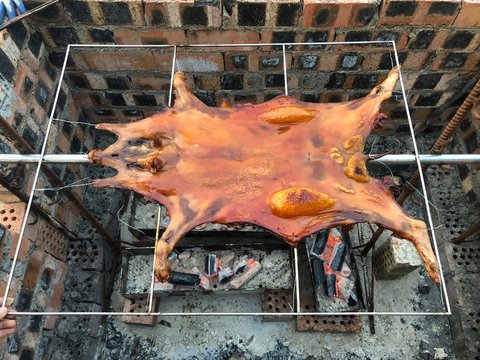 Fresh and delicious roast suckling pig, baked in a homemade red brick charcoal stove