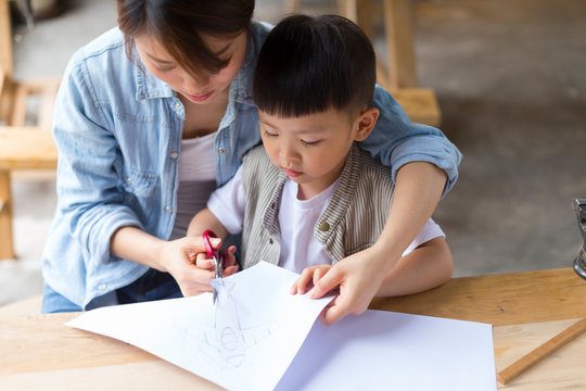 Woman working with her son in workshop