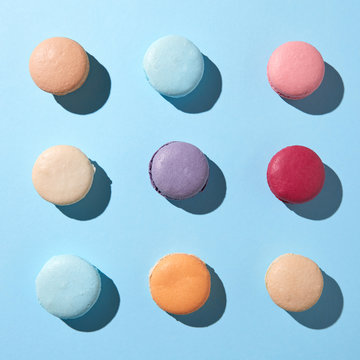Pattern of multi-colored macaroons on a blue background