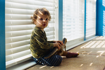 Toddler playing with a dinosaur toy