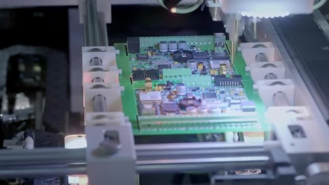 Electronic circuit board production. Automated Circut Board machine Produces Printed digital electronic board. Electronics contract manufacturing. Manufacture of electronic chips. High-tech.