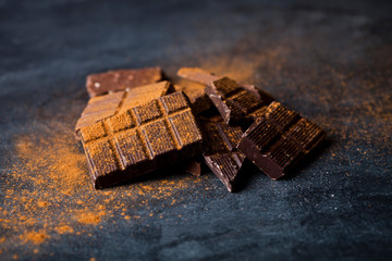 Chocolate bar pieces heap witn cinnamon powder.